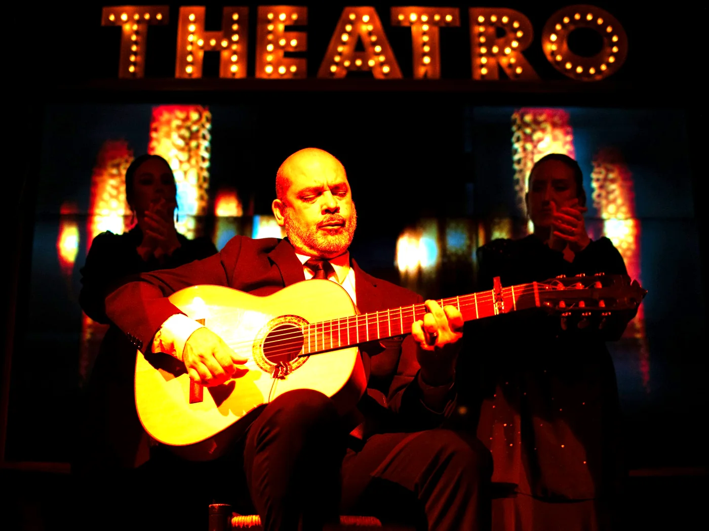 A flamenco guitarist playing on stage